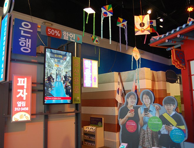View of a town in Korea featuring children and different decorations. 