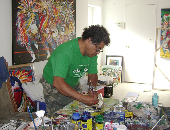 Artist painting on a canvas in his studio.