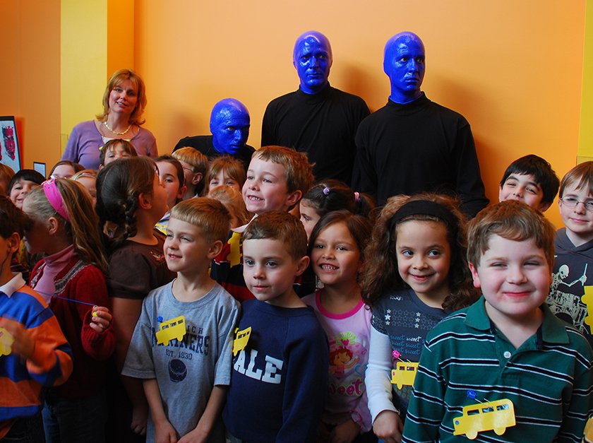 A group of students and teachers posed with members of the Blue Man Group. 