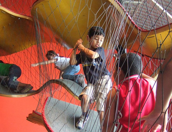 Children traveling through the Museums netted climbing structure.