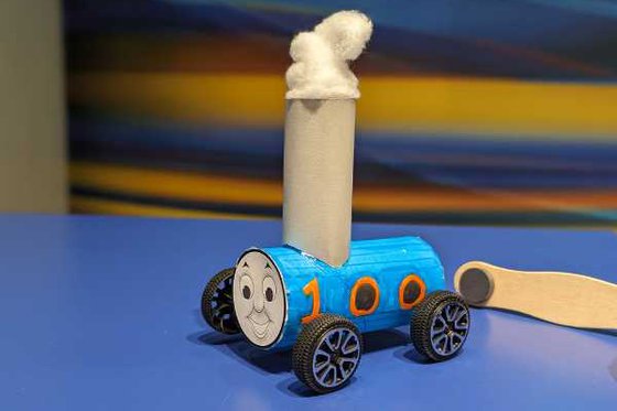 A blue paper Thomas the Train with plastic wheels and 'steam' made from a cotton ball. 
