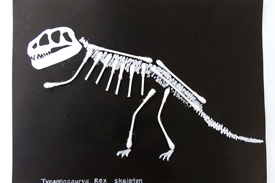 A T-Rex skeleton on black paper made with Q-Tips.  