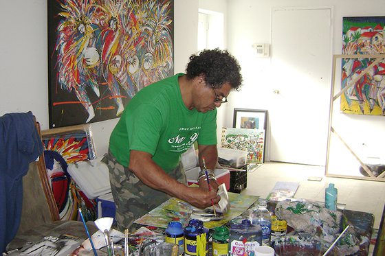 Artist painting on a canvas in his studio.