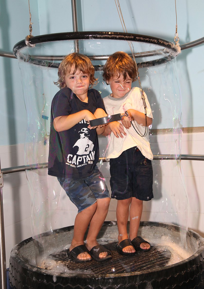 Two boys inside a bubble. 