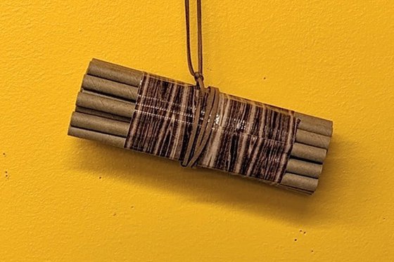 Slim cardboard tubes held together with string. 