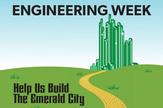A yellow brick road leads to green towers representing the Emerald City, set against a blue sky and green grass. A text overlay says "Engineering Week" and "Help us Build the Emerald City"