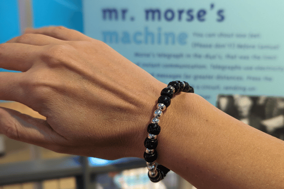 Bracelet made with black and white beads in a pattern using Morse Code alphabet.