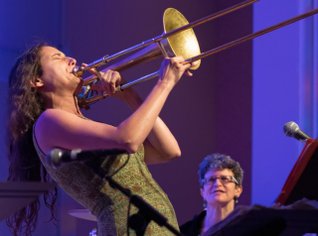 Trombone player actively playing instrument