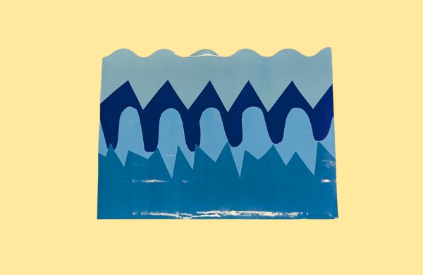 Square cardboard piece covered in layers of blue tape to simulate waves.