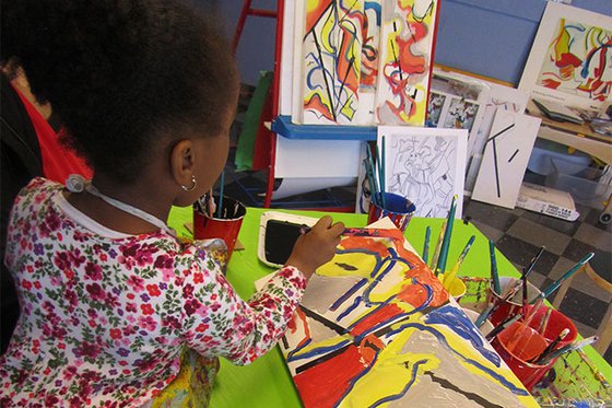 A young artist painting her DeKooning inspired piece on canvas. 