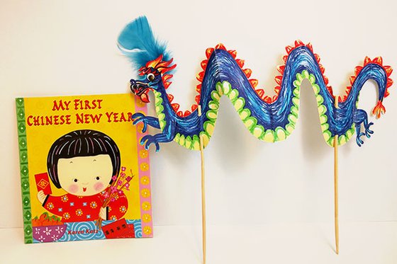 My First Chinese New Year book and a colorful dragon stick puppet.