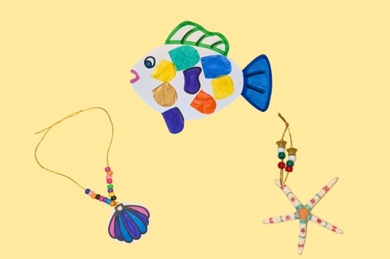 From left to right, a shell necklace, paper fish and starfish all decorated, set on a yellow background. 