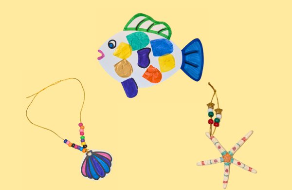 From left to right, a shell necklace, paper fish and starfish all decorated, set on a yellow background. 
