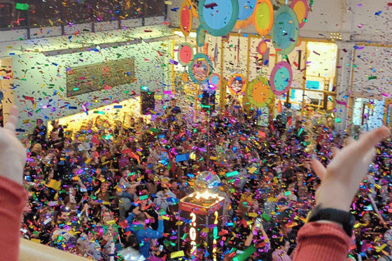 The Outer Lobby of LICM filled with people and confetti with a Time-Square style ball in the middle. 
