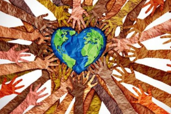 Skin tone diverse paper hands reaching for and surrounding a heartshaped globe. 