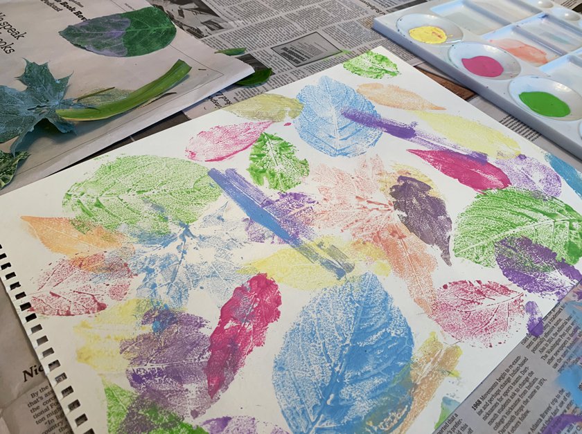 Colorful stencils of leaves on paper using paint. 