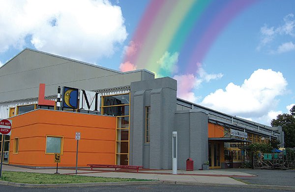 A picture of the back end of the Long Island Children's Museum with a rainbow in the background. 
