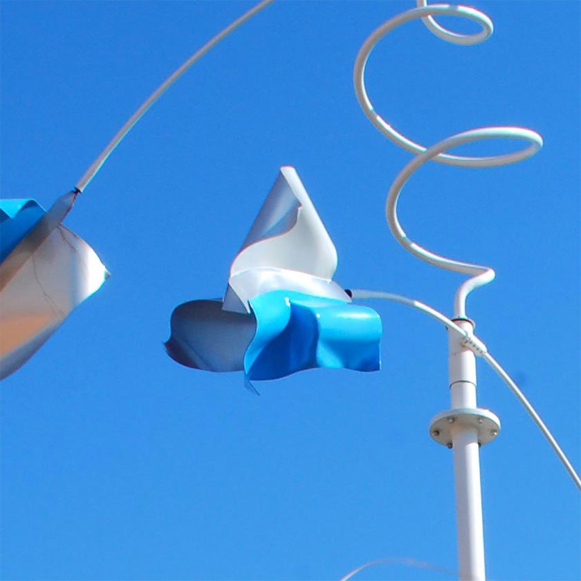 A metal blue and white sculpture created to move and spin with the wind as it blows.