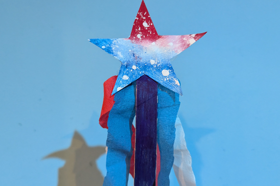 A red, white and blue star with red, white and blue streamers. 