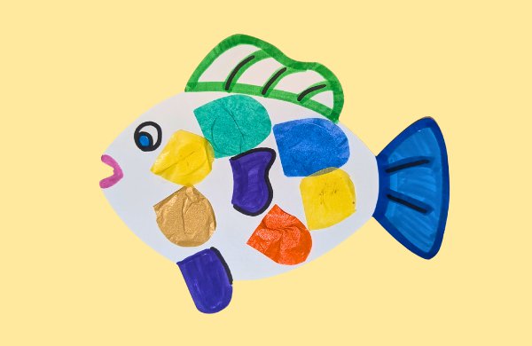 A paper colorful fish decorated with tissue paper scales on a yellow background.