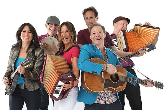 Six band members holding various instruments.