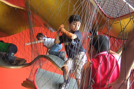 Children traveling through the Museums netted climbing structure.