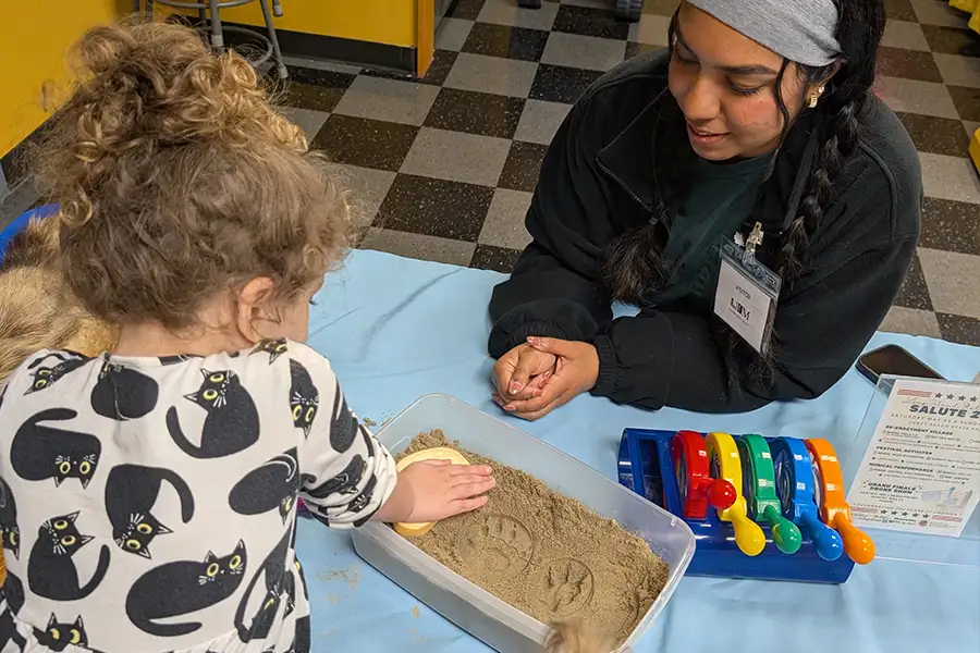 A family exploring exhibits together at Long Island Children's Museum.