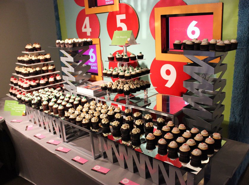 A tiered display of cupcakes set up for the Cupcakes & Cocktails gala.