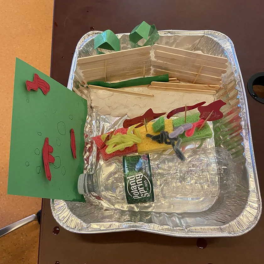 Families exploring storm surge solutions at a family workshop.