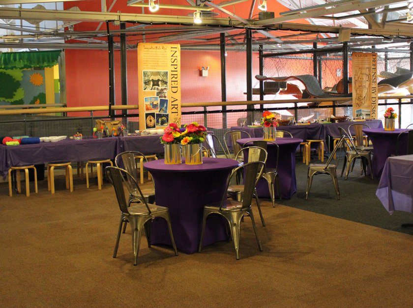Decorated tables set up inside KEVA exhibit for Museum rental.